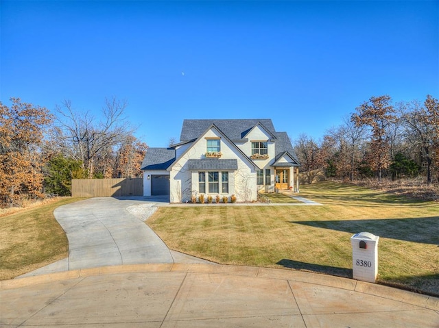 view of front of property featuring a garage and a front yard