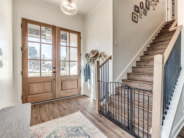 foyer with crown molding, french doors, and light hardwood / wood-style flooring