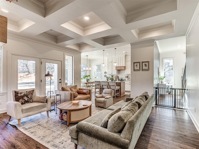 living room featuring hardwood / wood-style flooring, coffered ceiling, crown molding, and beam ceiling