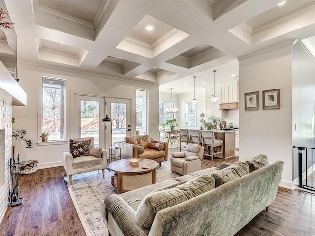 living room featuring beam ceiling, dark hardwood / wood-style flooring, crown molding, and a fireplace