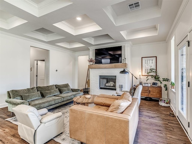 living room featuring hardwood / wood-style flooring, ornamental molding, a fireplace, and coffered ceiling