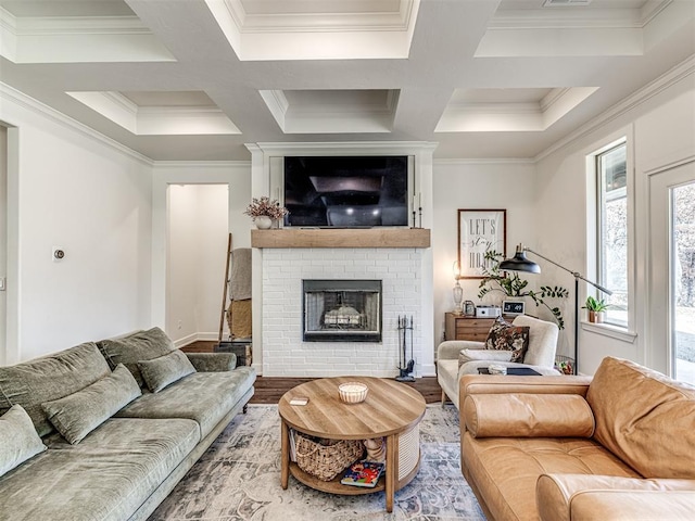 living room featuring coffered ceiling, wood-type flooring, crown molding, and a fireplace