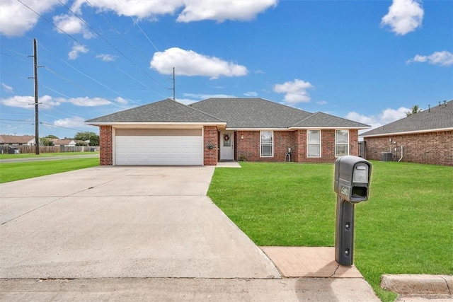 single story home with a garage, central air condition unit, and a front yard