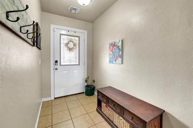 entryway with light tile patterned flooring