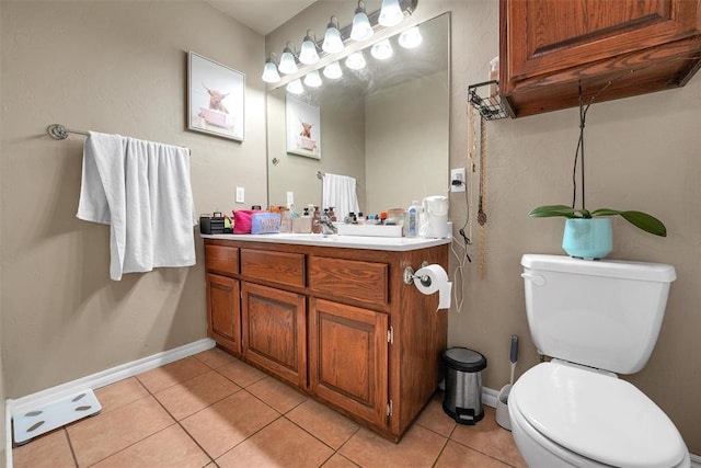 bathroom featuring tile patterned flooring, vanity, and toilet