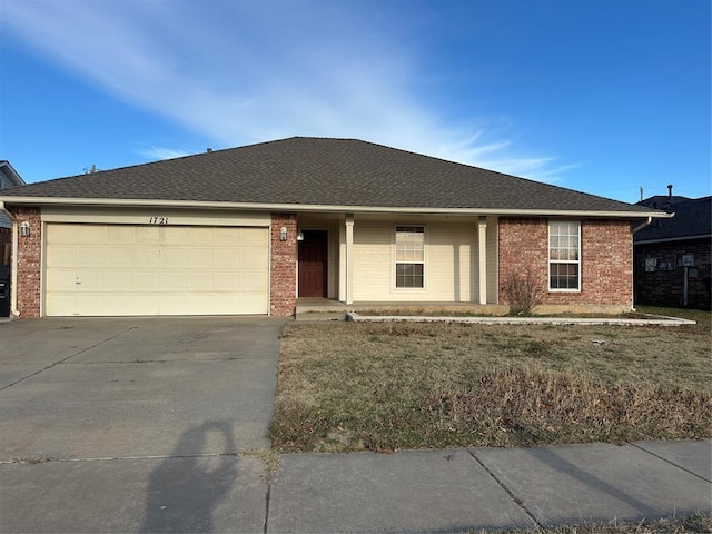 single story home featuring a front yard and a garage