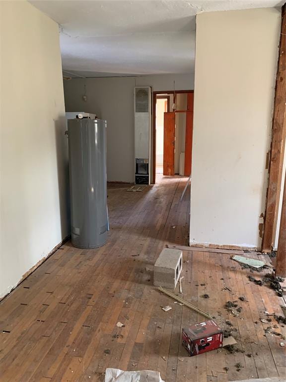 corridor featuring hardwood / wood-style floors and water heater