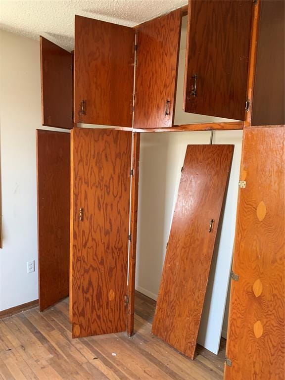 interior space featuring a textured ceiling and hardwood / wood-style flooring