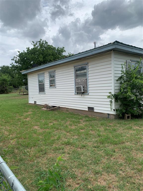 view of property exterior featuring a lawn and cooling unit