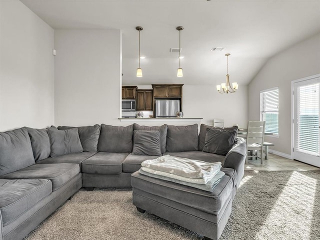 living room with vaulted ceiling and a notable chandelier