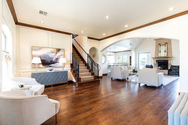 living room with dark hardwood / wood-style flooring, lofted ceiling, radiator heating unit, and ornamental molding