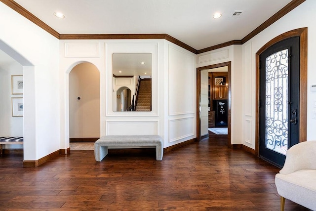 entryway featuring plenty of natural light, dark hardwood / wood-style flooring, and crown molding