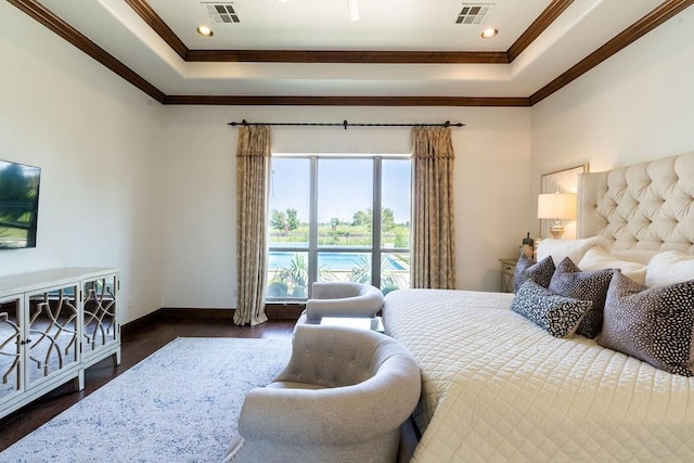 bedroom with a raised ceiling, dark hardwood / wood-style flooring, and ornamental molding