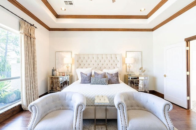 bedroom featuring a raised ceiling, dark hardwood / wood-style floors, and ornamental molding