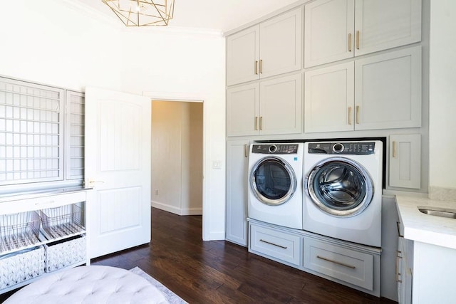 laundry area featuring cabinets, separate washer and dryer, dark hardwood / wood-style flooring, a notable chandelier, and crown molding