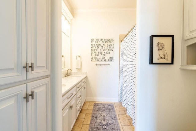 bathroom with walk in shower, vanity, and ornamental molding