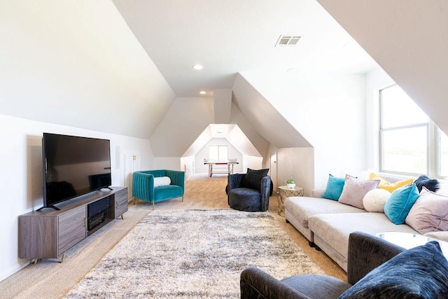 carpeted living room featuring vaulted ceiling