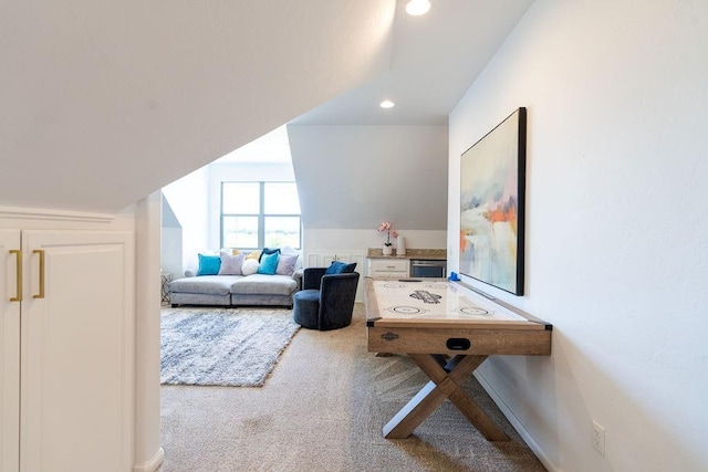 rec room with carpet floors and vaulted ceiling