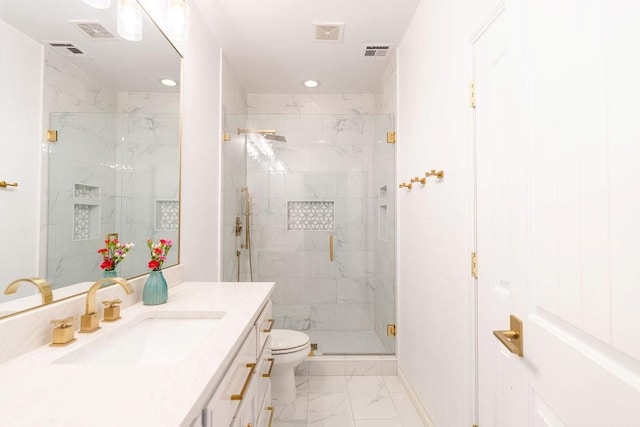 bathroom with vanity, toilet, and an enclosed shower