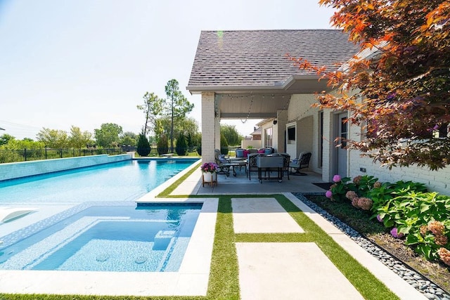 view of pool featuring an in ground hot tub and a patio