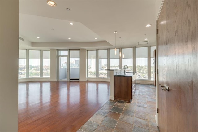 kitchen featuring pendant lighting, sink, and a kitchen island with sink