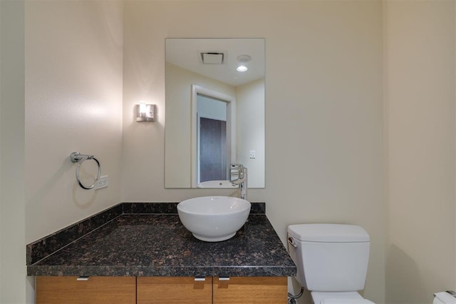 bathroom featuring vanity and toilet