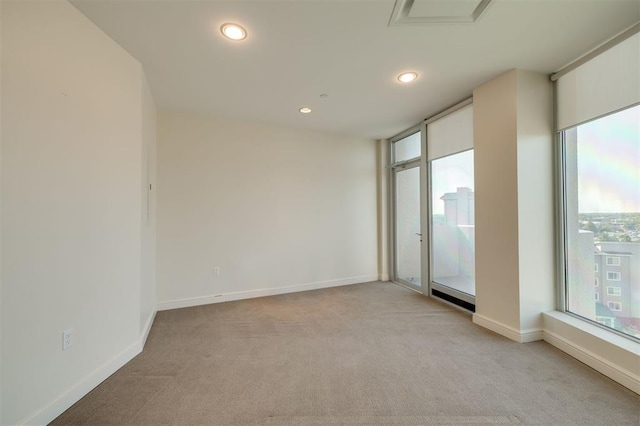 spare room with light colored carpet