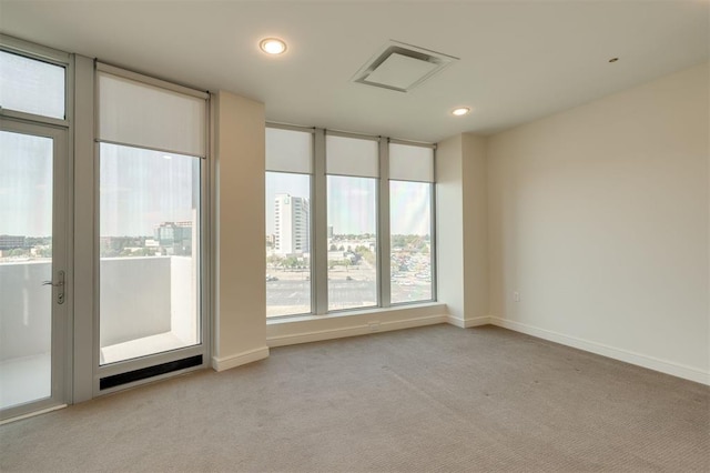 unfurnished room featuring light colored carpet