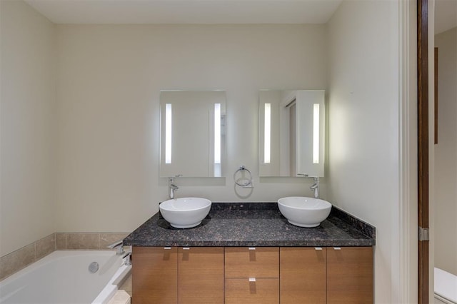 bathroom featuring vanity, toilet, and a bathtub