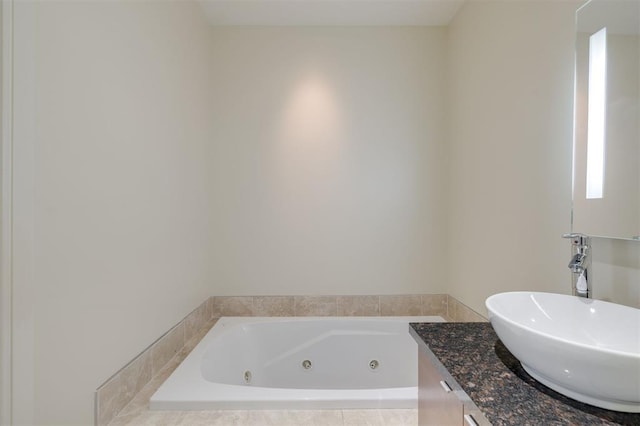 bathroom featuring vanity and tiled bath