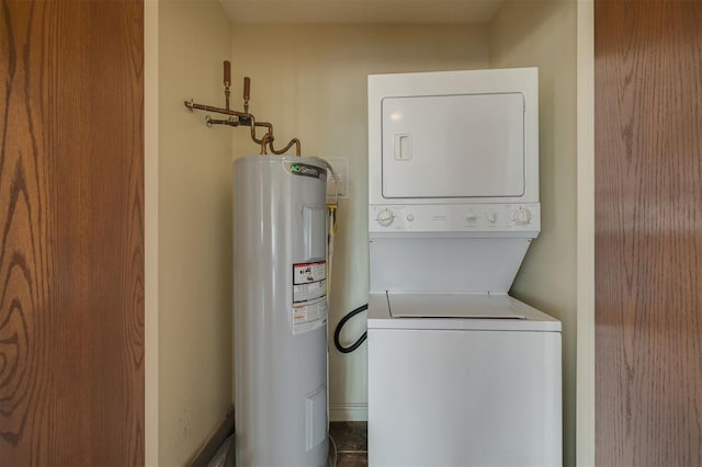 clothes washing area with stacked washer and clothes dryer and water heater