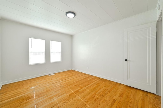 unfurnished room with hardwood / wood-style flooring