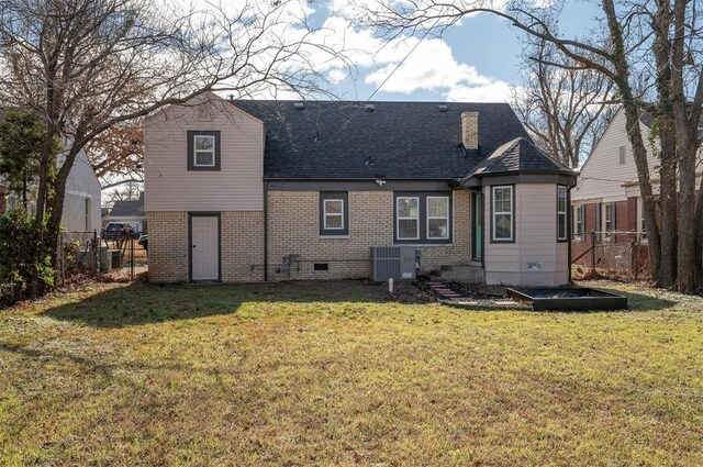 back of property featuring a lawn and cooling unit