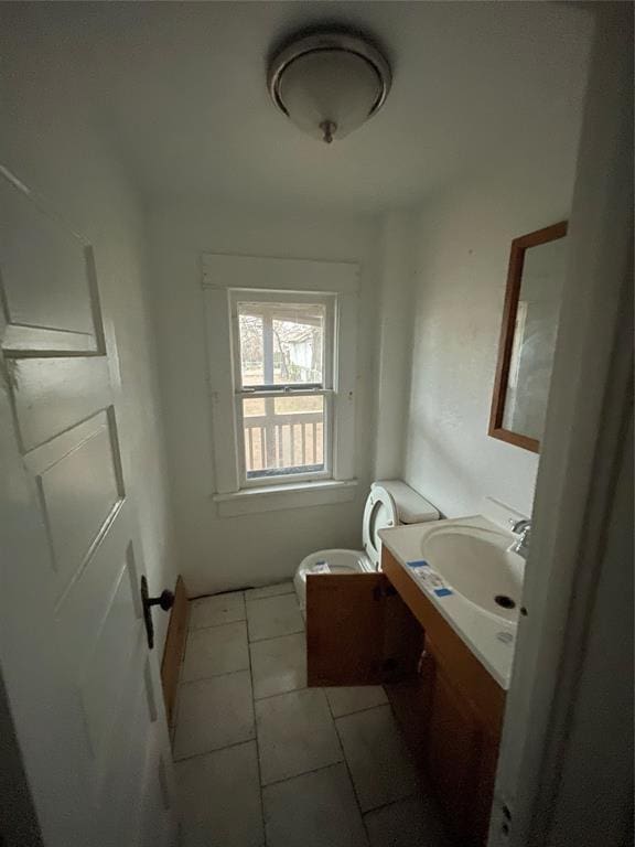 bathroom featuring tile patterned flooring, vanity, and toilet