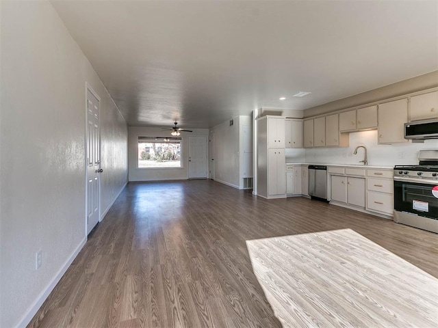 kitchen with hardwood / wood-style flooring, ceiling fan, sink, and appliances with stainless steel finishes