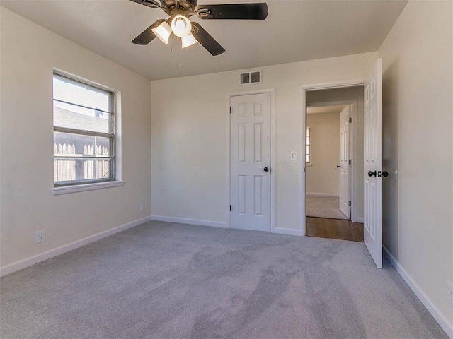 unfurnished bedroom with light colored carpet and ceiling fan