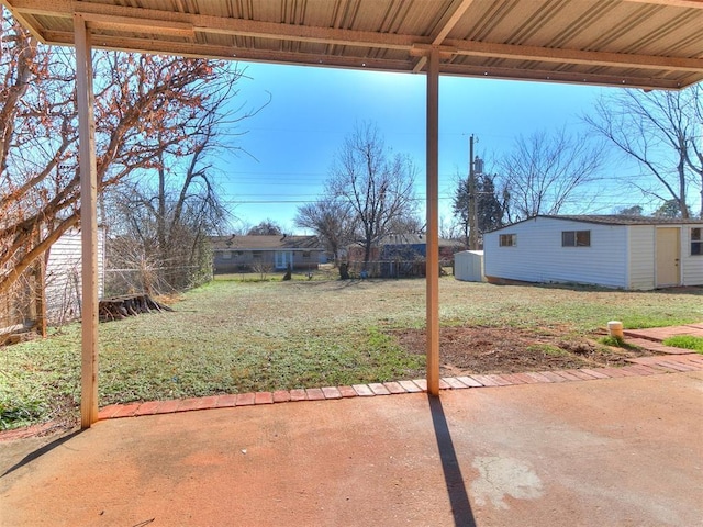 view of yard featuring a patio and a shed