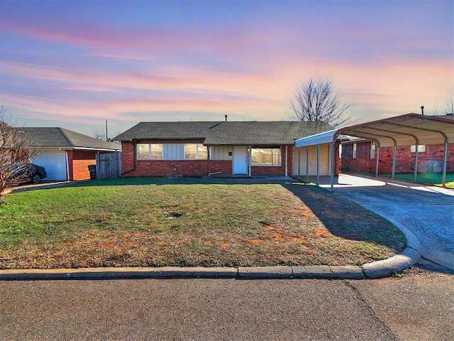 ranch-style home with a yard and a carport