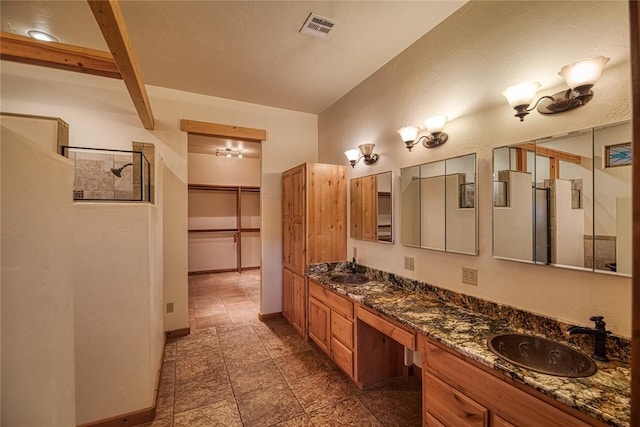 bathroom featuring vanity and walk in shower