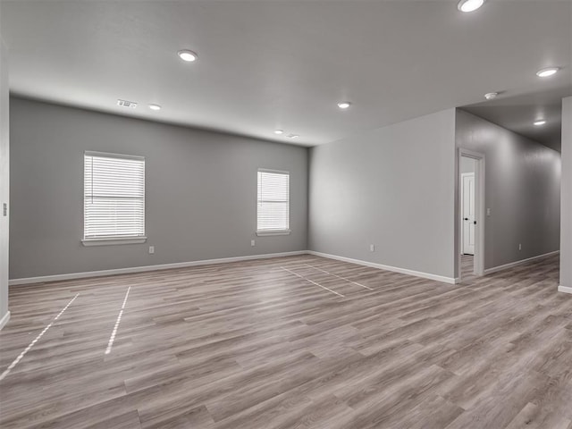 empty room with light hardwood / wood-style flooring