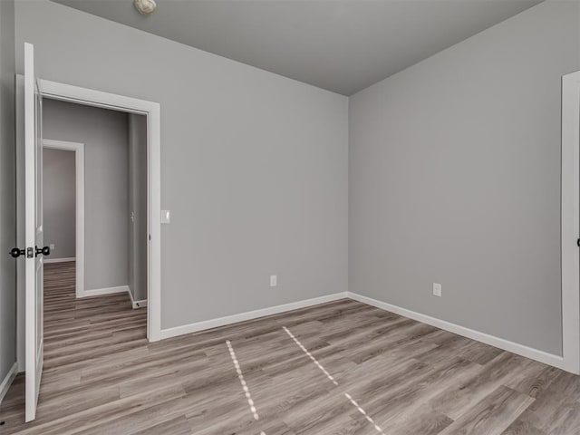 unfurnished room with light hardwood / wood-style floors