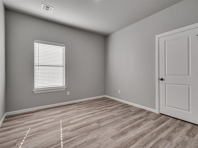 empty room with light hardwood / wood-style floors