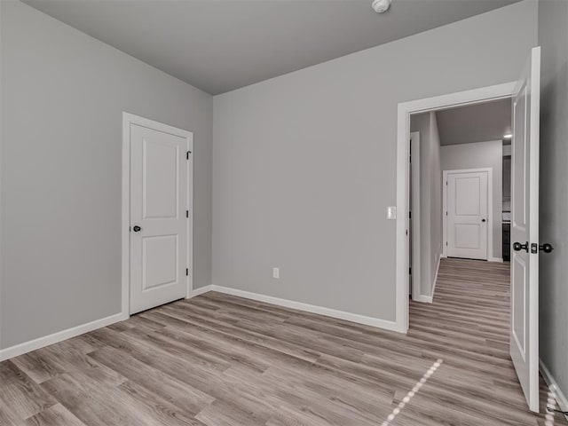 spare room with light hardwood / wood-style floors