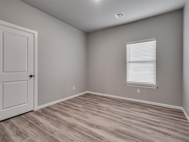 spare room featuring light hardwood / wood-style flooring