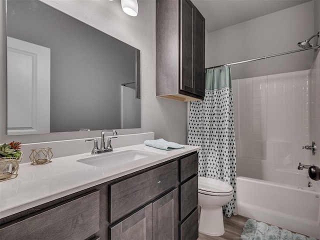 full bathroom featuring hardwood / wood-style floors, vanity, toilet, and shower / bath combo with shower curtain