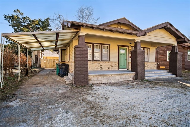 craftsman house featuring covered porch and a carport