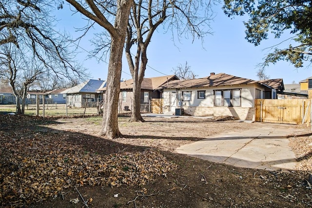 back of house featuring cooling unit