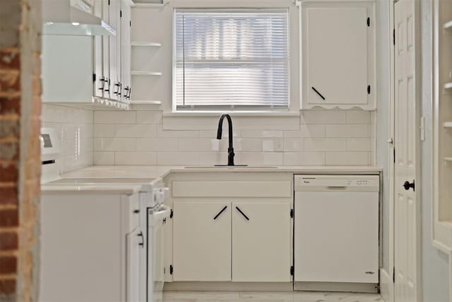 kitchen featuring white cabinets, dishwasher, plenty of natural light, and sink