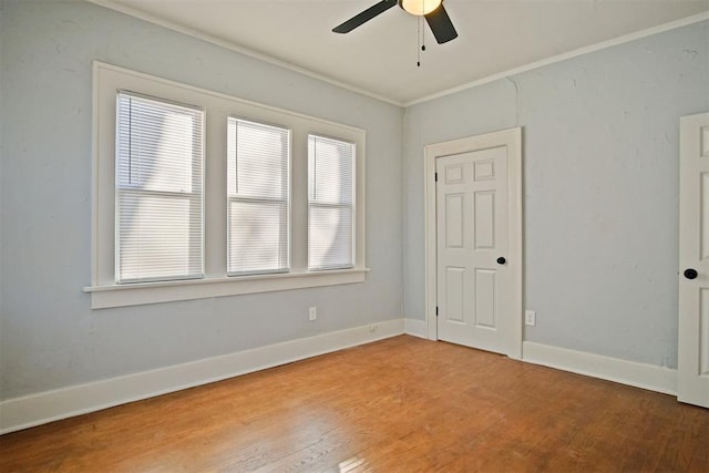 unfurnished room with hardwood / wood-style flooring, ceiling fan, and ornamental molding