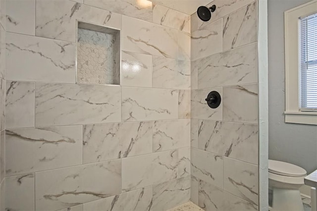 bathroom with toilet and tiled shower